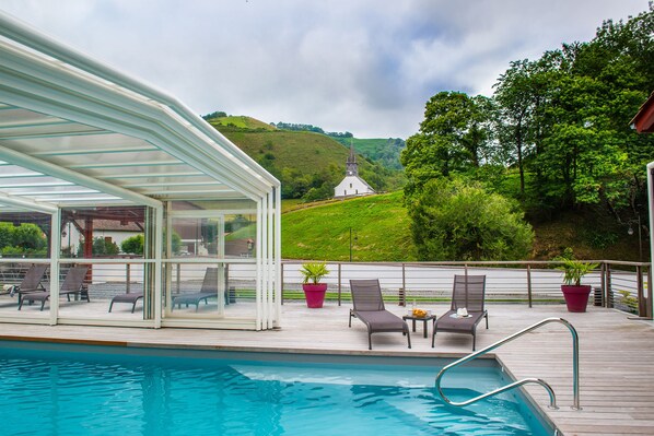 Seasonal outdoor pool, open 10:00 AM to 7:00 PM, pool umbrellas