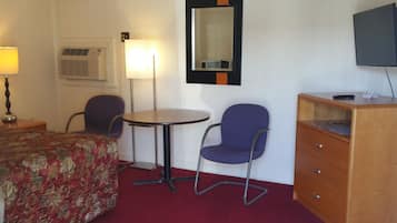Relax in this inviting space with a comfortable bed, a round table for dining, and a dresser for storing your belongings.