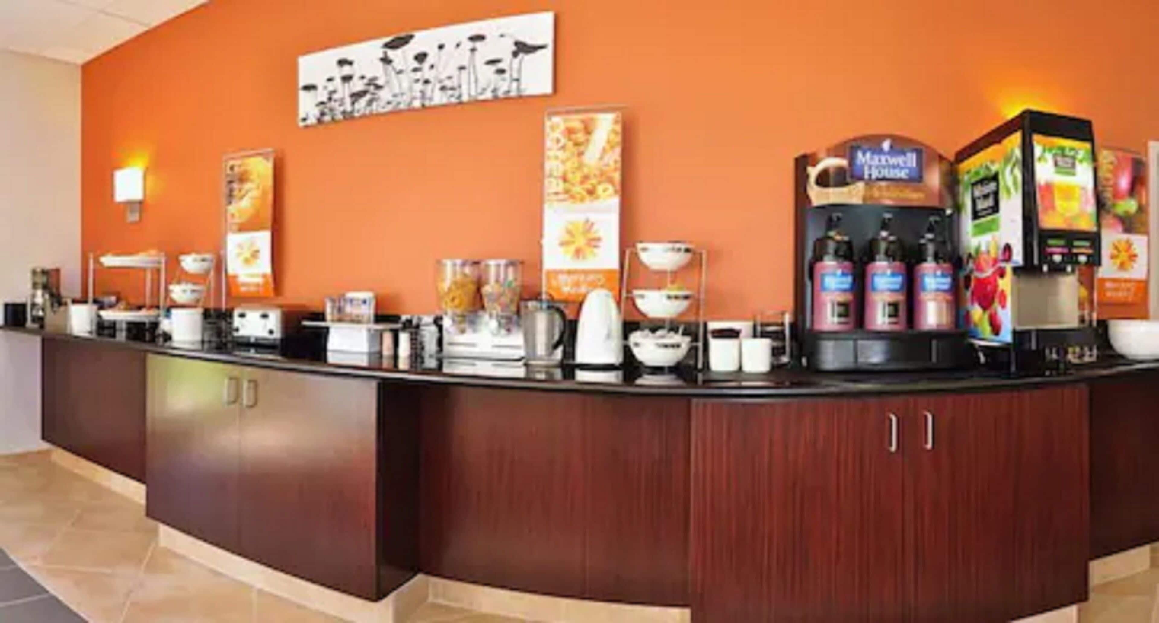 A hotel reception area with a coffee station, a buffet setup, and a sign for the Marriott House.