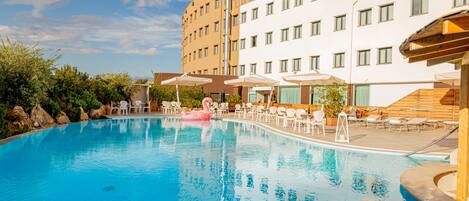 Seasonal outdoor pool, open 9 AM to 6:30 PM, pool umbrellas