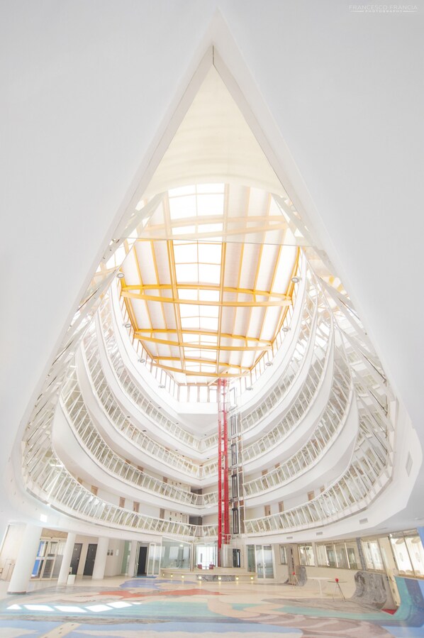 A multi-level atrium with a central open space and a glass ceiling. - Mercure Olbia Hotel and Spa (Olbia)