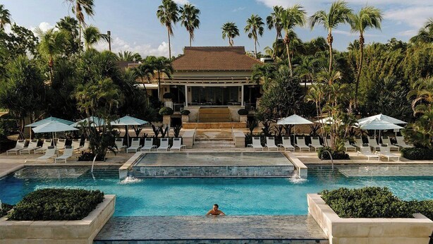 A resort pool with multiple levels, palm trees, and lounge chairs. - Four Seasons Resort and Residences Puerto Rico (Río Grande)