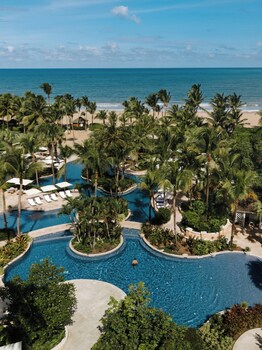 Outdoor pool, sun loungers at Four Seasons Resort and Residence Puerto Rico