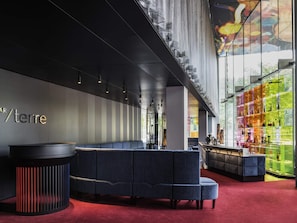 Un hall d’entrée moderne doté d’un espace salon, d’un bar et d’une grande fenêtre offrant une vue panoramique.