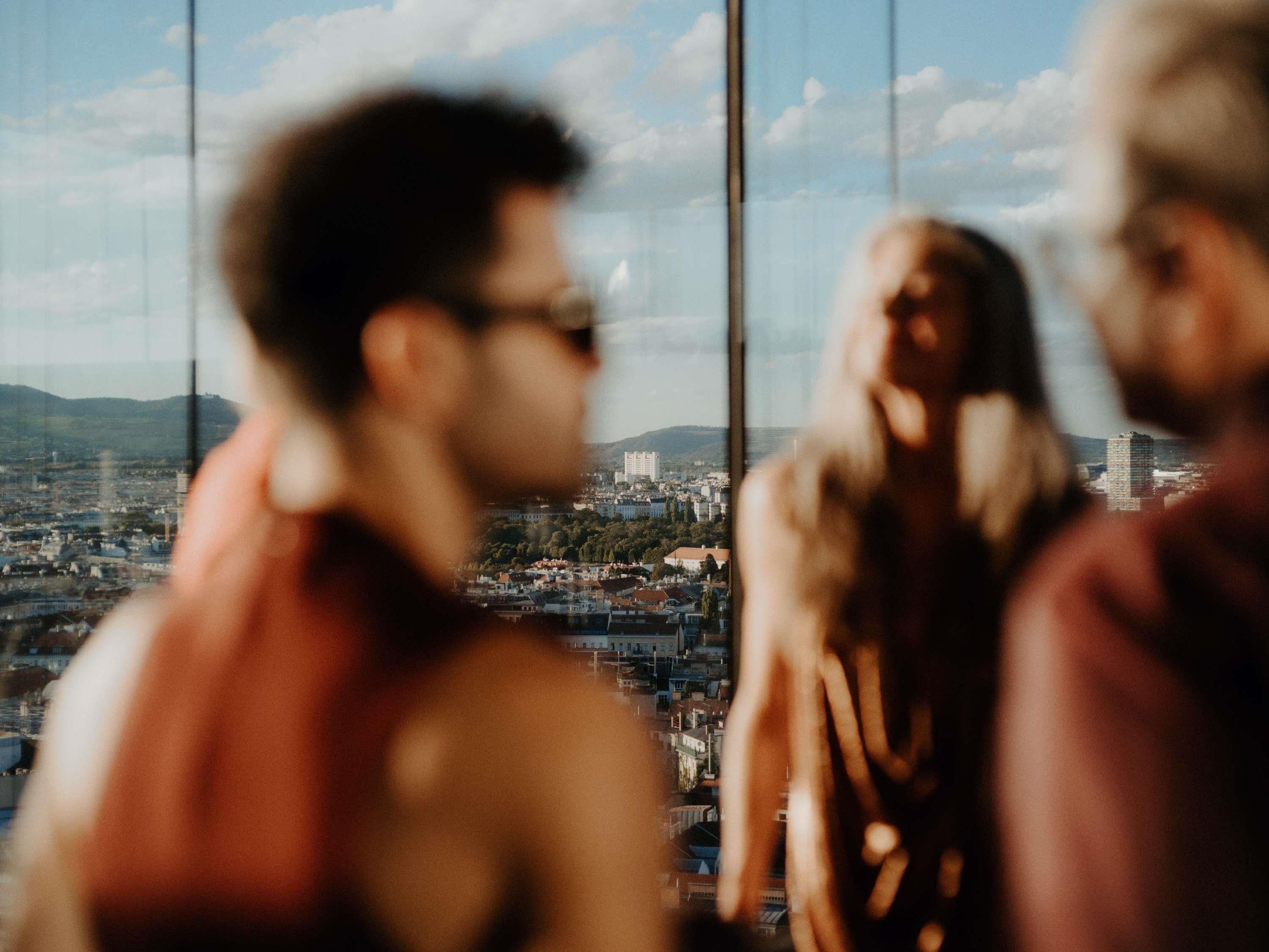 A view through a window with a cityscape in the background.