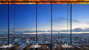 A high-rise restaurant with a panoramic city view through large windows. - SO/ Vienna (Vienna)
