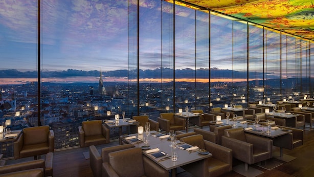 A restaurant with a city view, large windows, and a ceiling with a leaf pattern. - SO/ Vienna (Vienna)