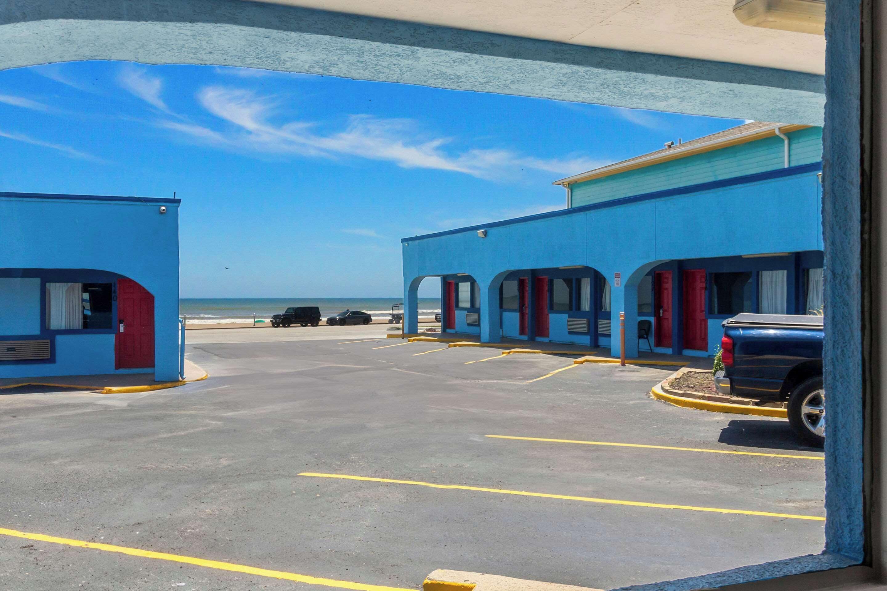 A parking lot with a building that has multiple rooms.