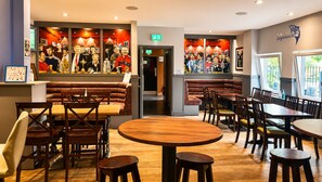 A restaurant interior with booths, tables, and chairs. - Great Western Hotel Aberdeen (Aberdeen)