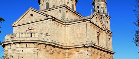 A large, historic building with a prominent dome and two towers.