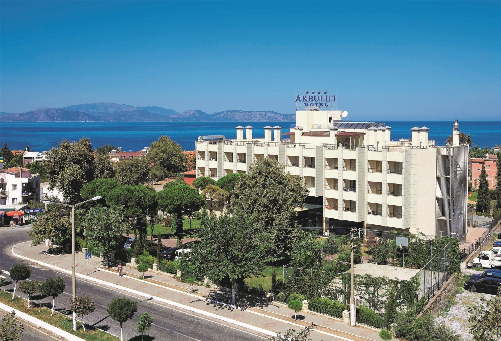 A hotel with a view of the sea and mountains.