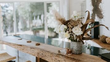 Enjoy a clean and contemporary space with a large window, wooden countertop, and elegant vase.