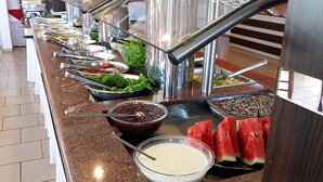 A buffet with various food items including salads, fruits, and dips. - Praia Sol Hotel (Santa Terezinha do Itaipu)
