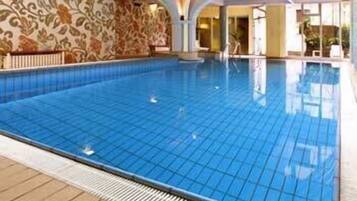 Swimmers can enjoy a refreshing dip in the indoor pool surrounded by a spacious deck area.