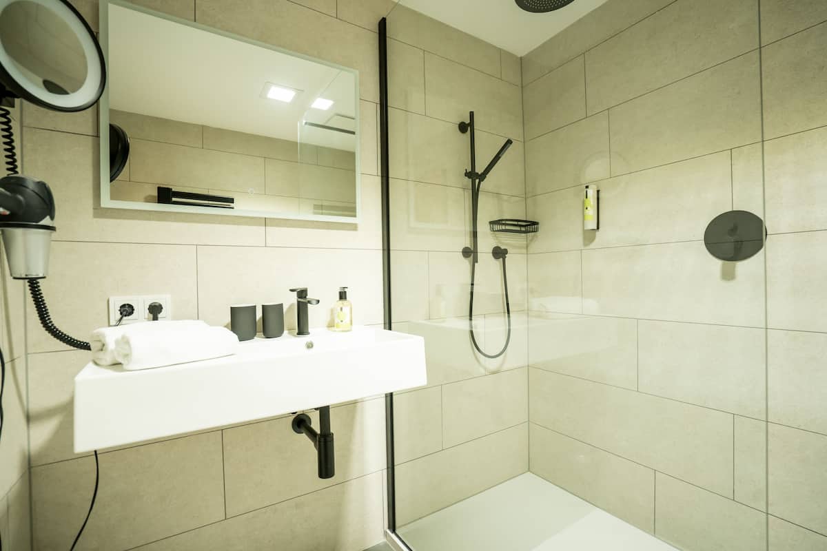 junior studio suite | bathroom | hair dryer, bathrobes, towels, soap