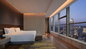 A modern hotel room with a large bed, bedside table, and a view of the cityscape. - Holiday Inn Beijing Focus Square by IHG (Beijing)