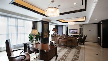 A spacious conference room with a large table, chairs, and a television.