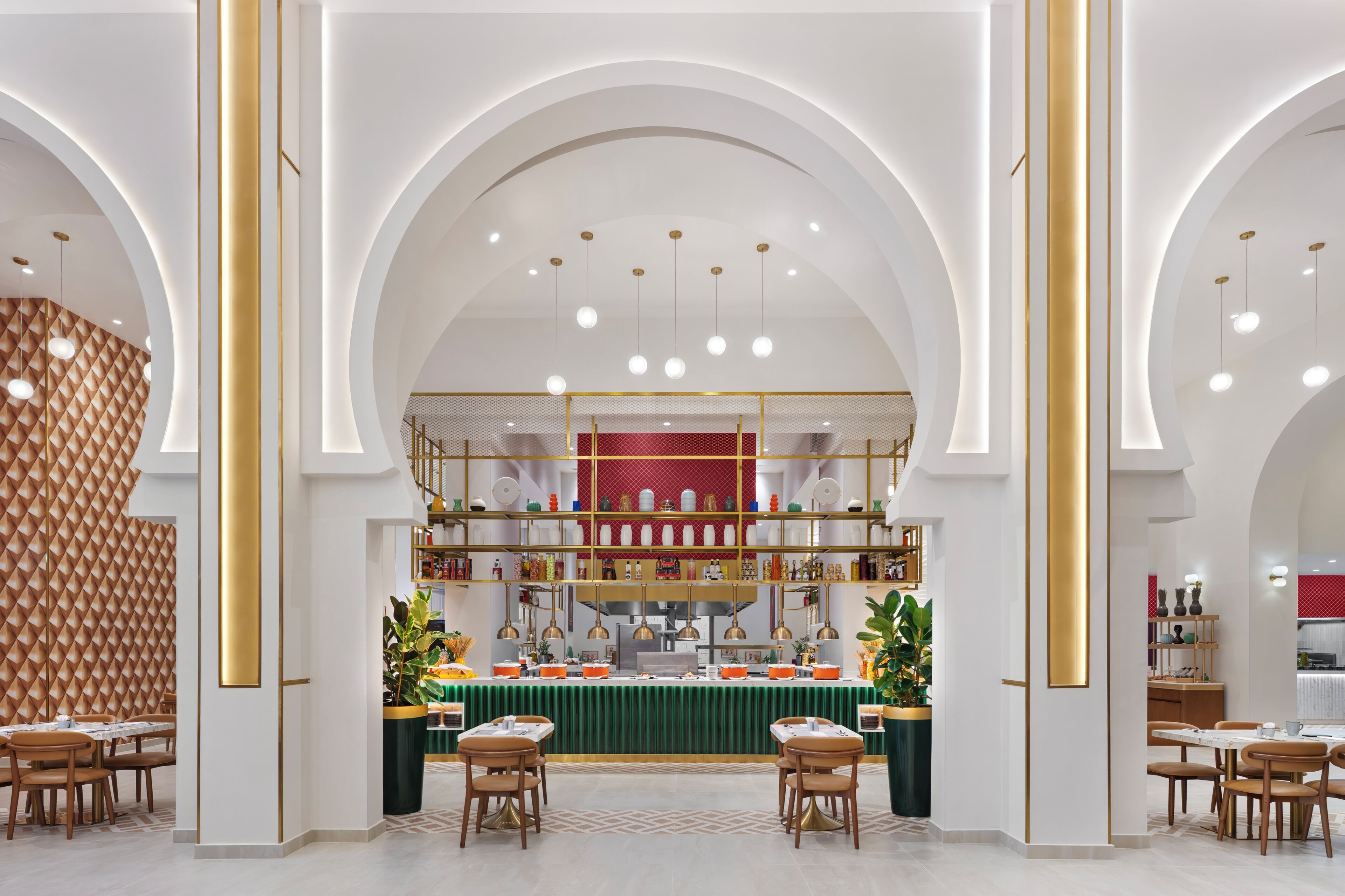 A modern interior with a central serving area, multiple seating arrangements, and a distinctive geometric wall pattern.