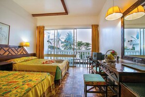 A hotel room with two beds, a desk, a chair, a large window with a view of palm trees, and a balcony. - Mombasa Beach Hotel (Mombasa)