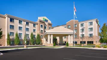Stunning hotel entrance with a central walkway and beautifully landscaped surroundings.