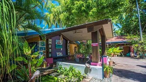 A tropical resort with a reception area, outdoor seating, and lush greenery. - Pink Flamingo Resort (Port Douglas)