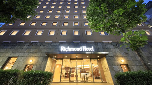 A hotel with a modern facade, large windows, and a sign that reads "Richmond Hotel".