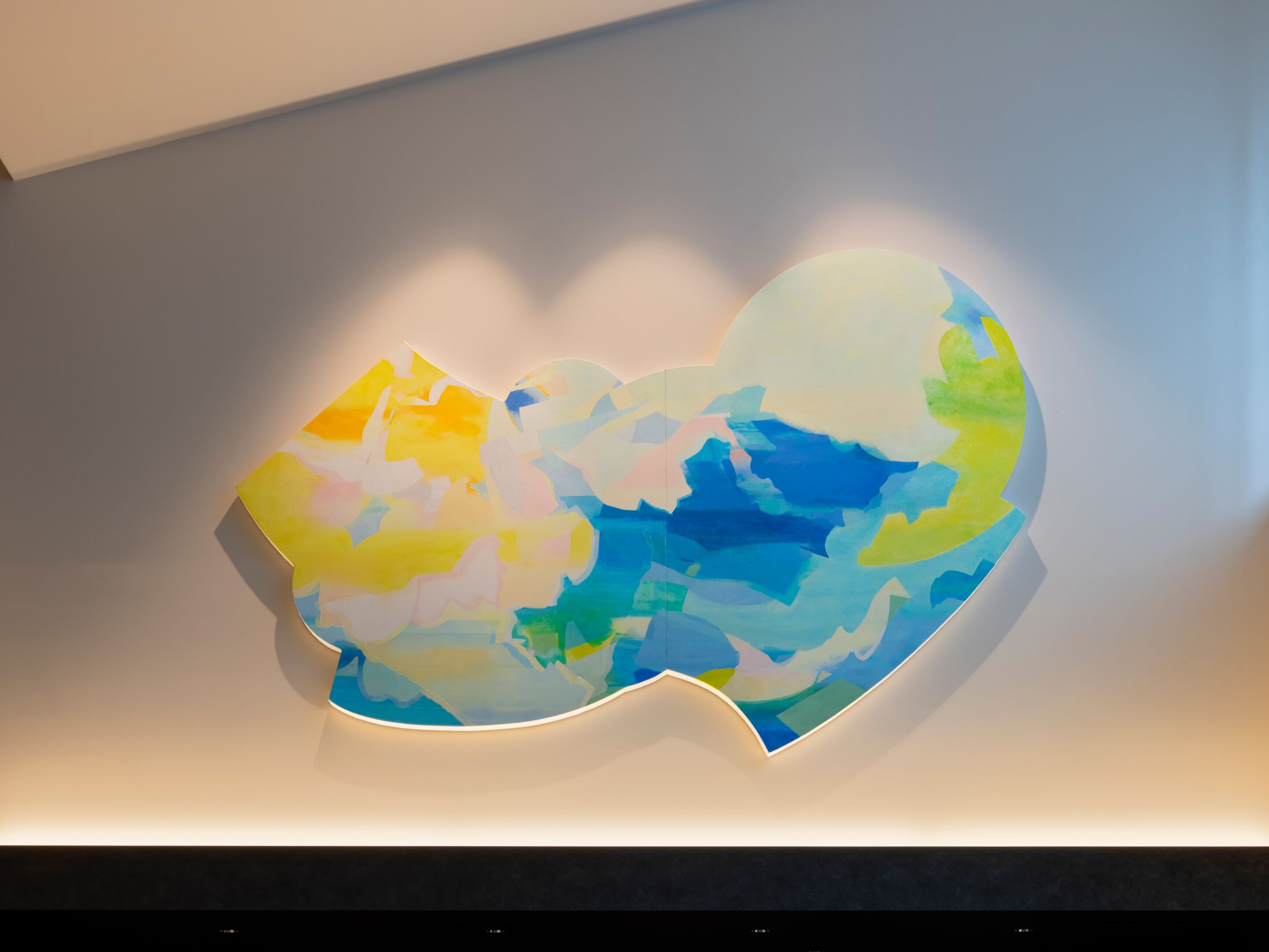 A modern wall art installation with abstract shapes and a soft glow.