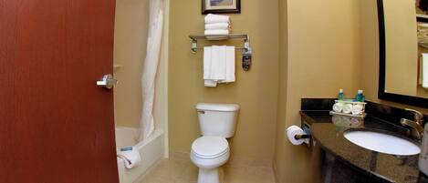 A bathroom with a toilet, a bathtub, a sink, and a towel rack.