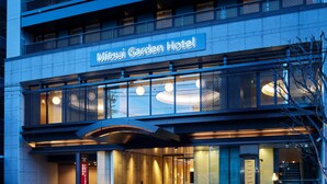 The exterior of Mitsui Garden Hotel with a modern architectural design, featuring a prominent entrance and a sign above the main entrance. - Mitsui Garden Hotel Kyoto Shijo (Kyoto)