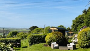 A countryside property with a green house, a white chair, and a hedge. - Beacon Country House Hotel (St. Agnes)