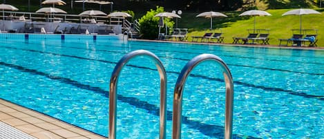 Seasonal outdoor pool, open 11:00 AM to 8:00 PM, pool umbrellas