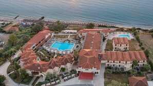 An aerial view of a resort with multiple buildings, a swimming pool, and a beach. - Blue Bay Halkidiki “Adults Only ” (Kassandra)