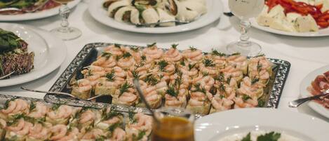 A buffet table with various dishes and drinks.