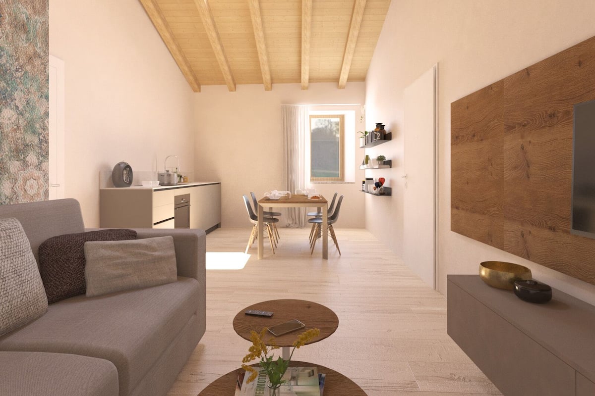 Un espacio moderno para vivir con comedor, kitchenette y un gran techo de vigas de madera.