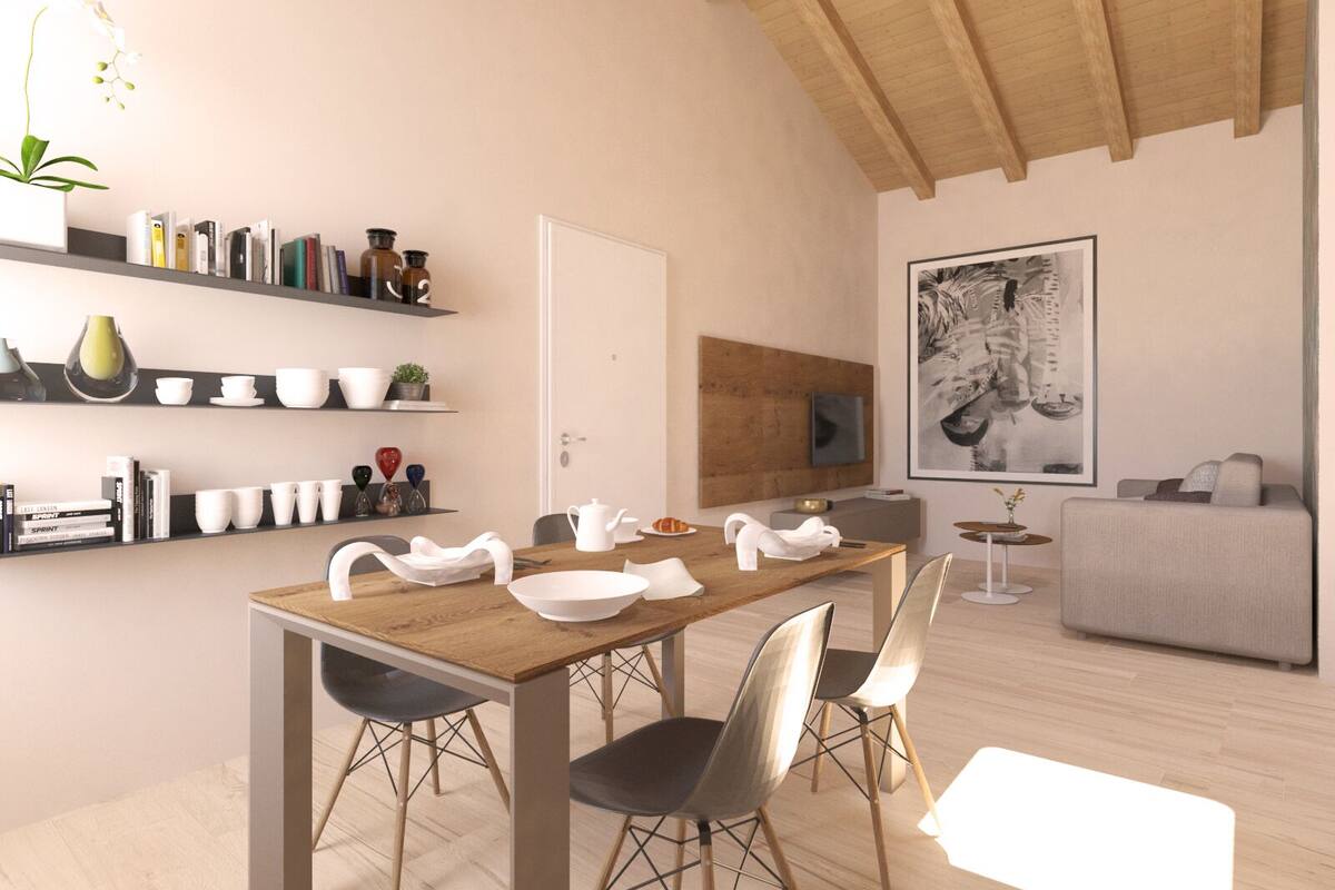 Un comedor moderno con una mesa de madera, sillas negras y un jarrón blanco.