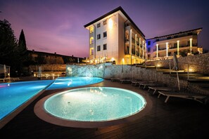 Guests can enjoy a relaxing stay with access to a well-lit outdoor pool and hot tub.
