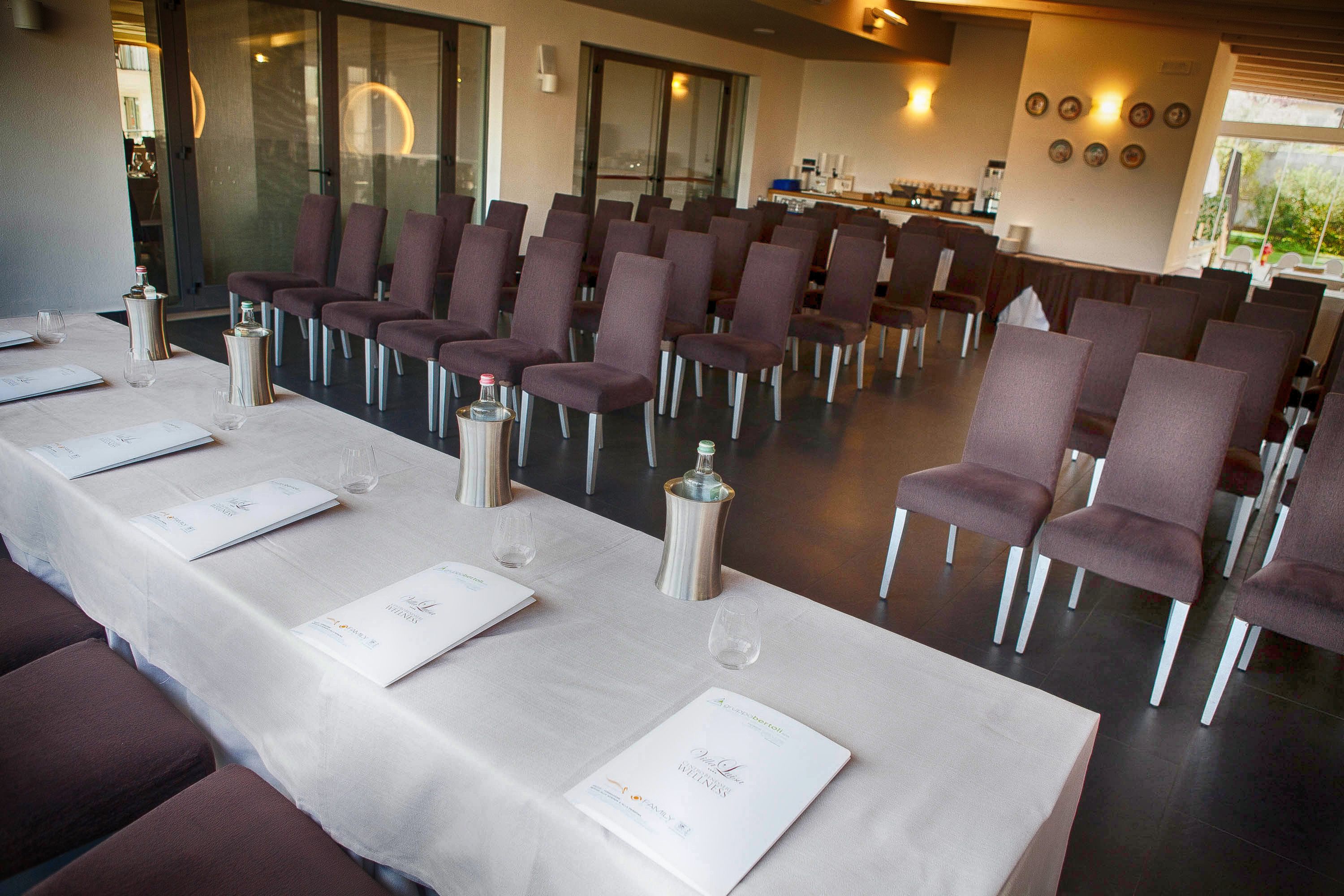 A conference room with rows of chairs and tables set up for a meeting.