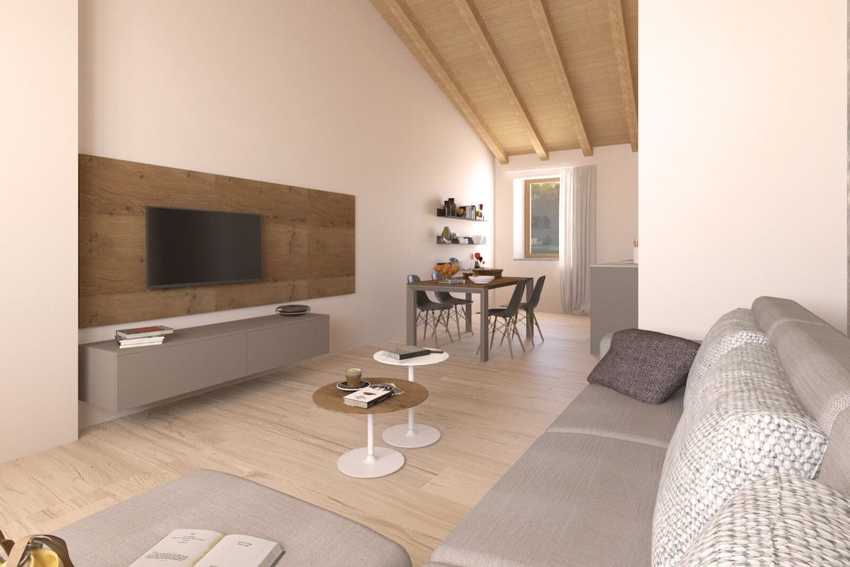 Una sala de estar moderna con un televisor de pantalla plana montado en un panel de madera, un sofá gris, una mesa de centro y un comedor con mesa y sillas.
