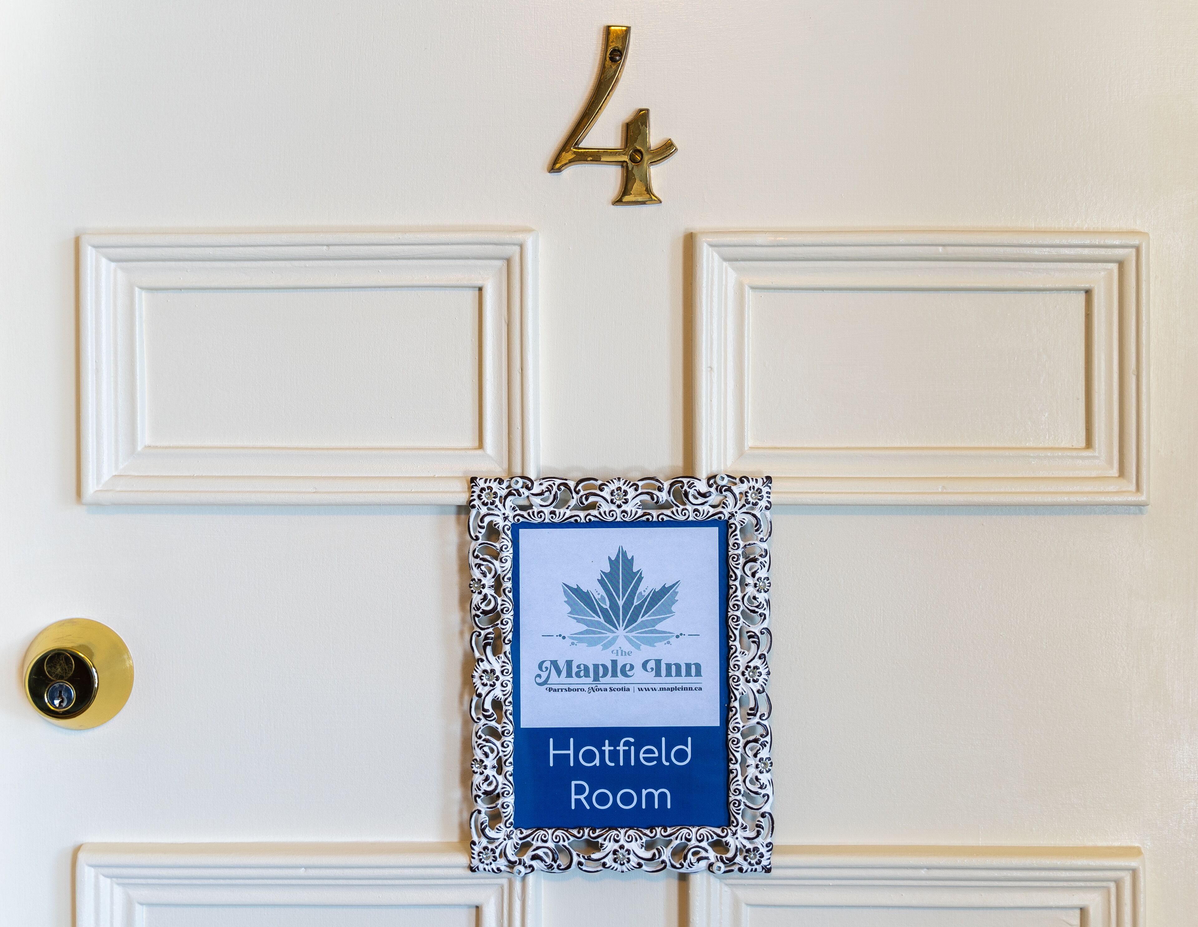 A door with a sign indicating "Maple Inn Hatfield Room" and a brass number "4" above it.