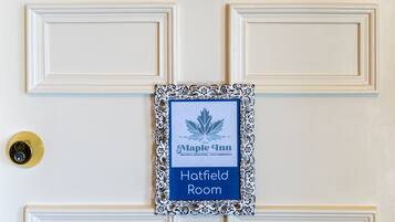 A door with a sign indicating "Maple Inn Hatfield Room" and a brass number "4" above it.