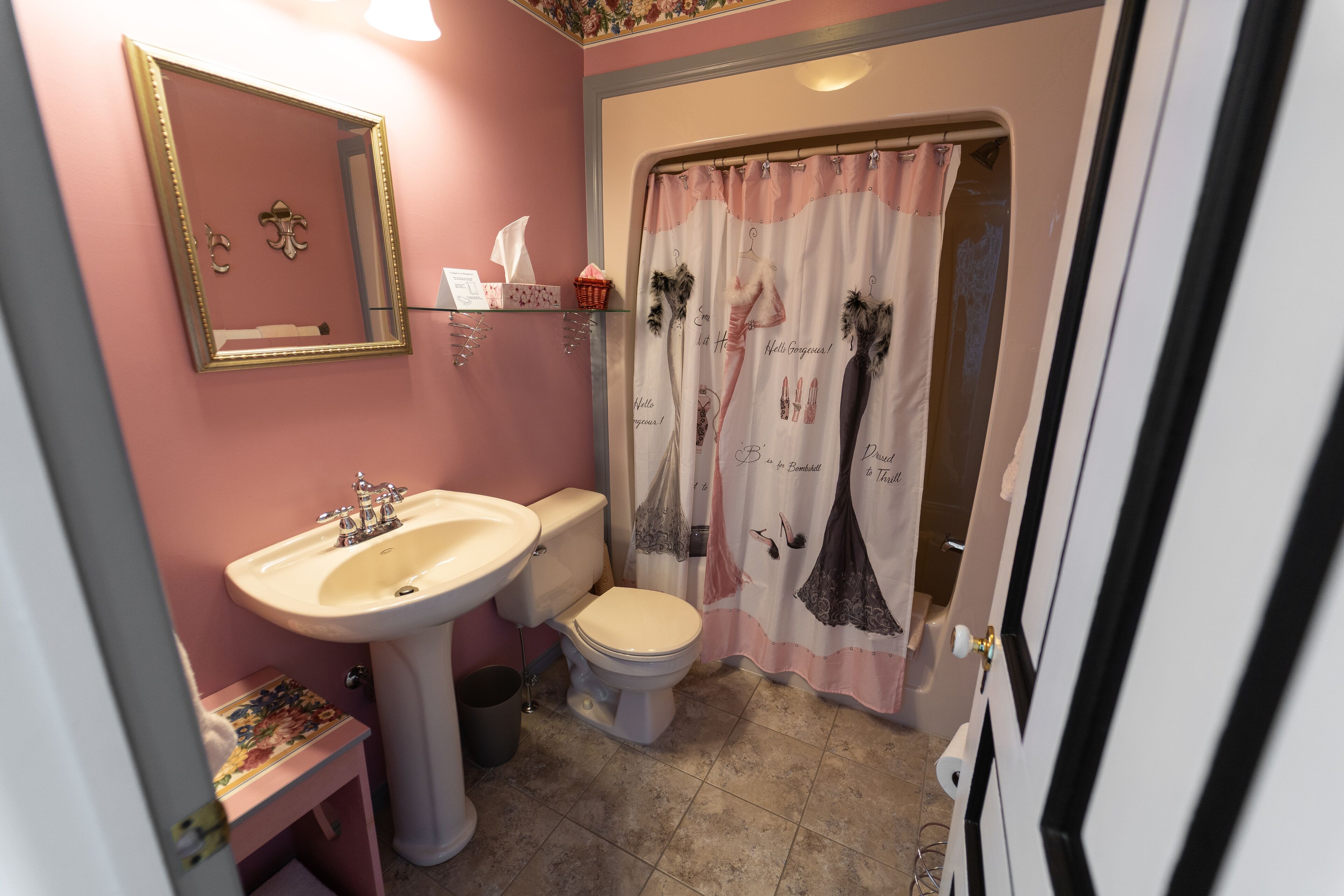 A bathroom with a sink, toilet, and shower curtain.