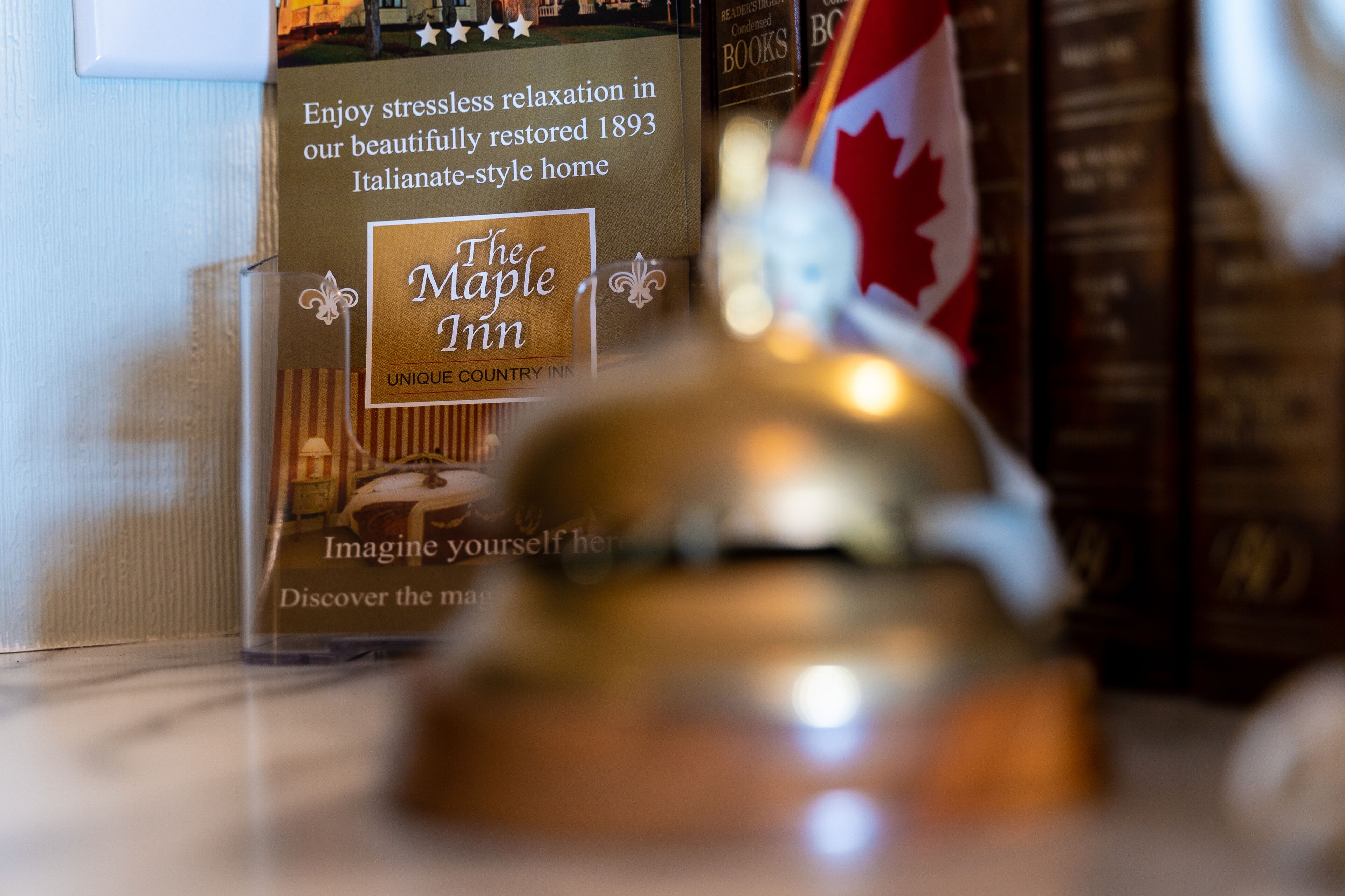 A book titled "The Maple Inn" with a description of a 1893 Italianate-style home.