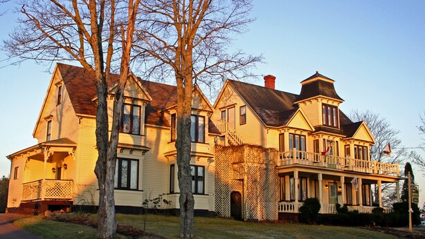 A large, two-story house with a wrap-around porch and a chimney. - The Maple Inn B&B (Parrsboro)