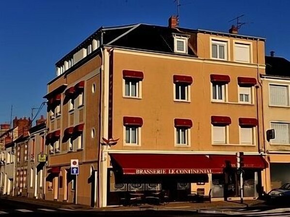 Un edificio con toldo rojo que dice "BRASSERIE DE CONTINENTAL".