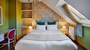 Une chambre à coucher avec un grand lit, deux lampes de chevet, un bureau et une chaise.
