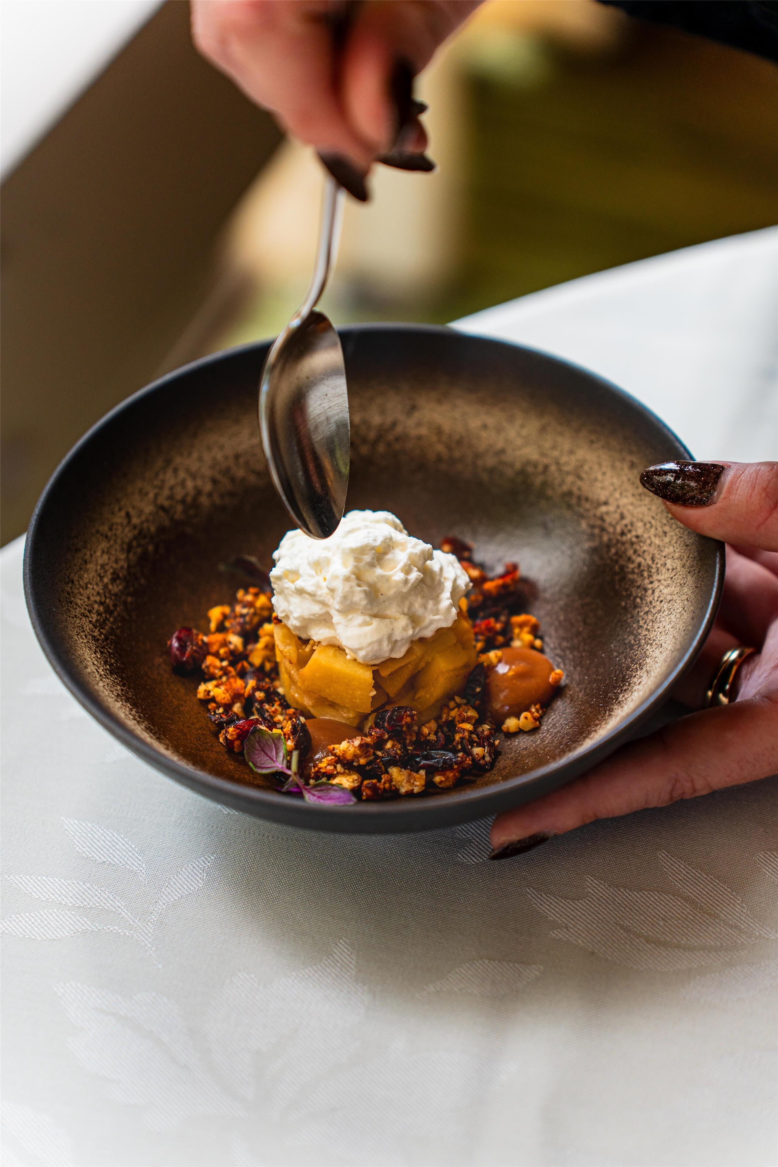 A dessert in a bowl with a spoon.