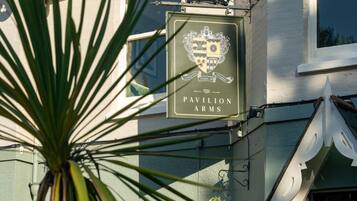 A building with a sign for 'The Pavilion Arms' pub.