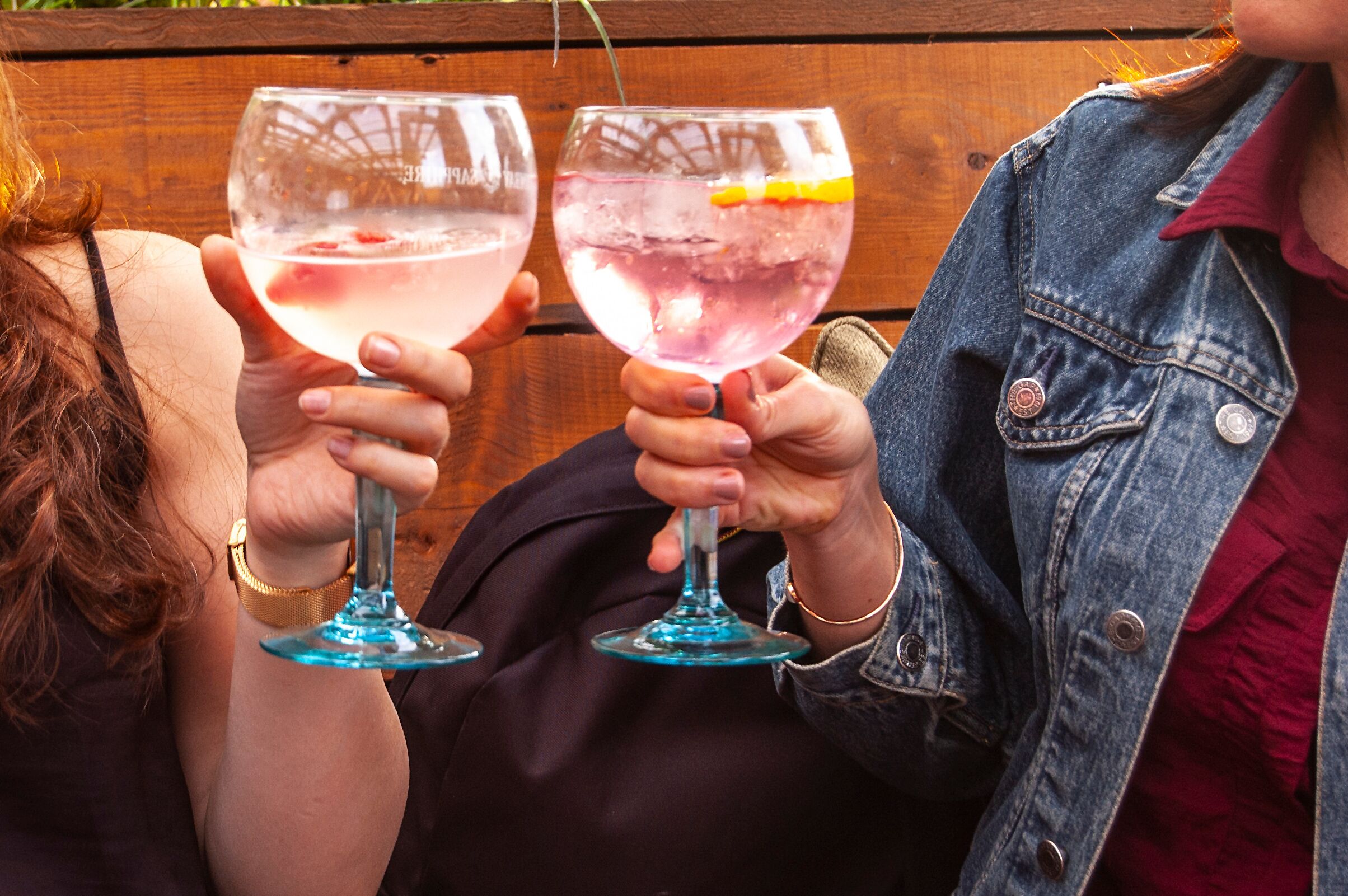 Two people holding wine glasses.