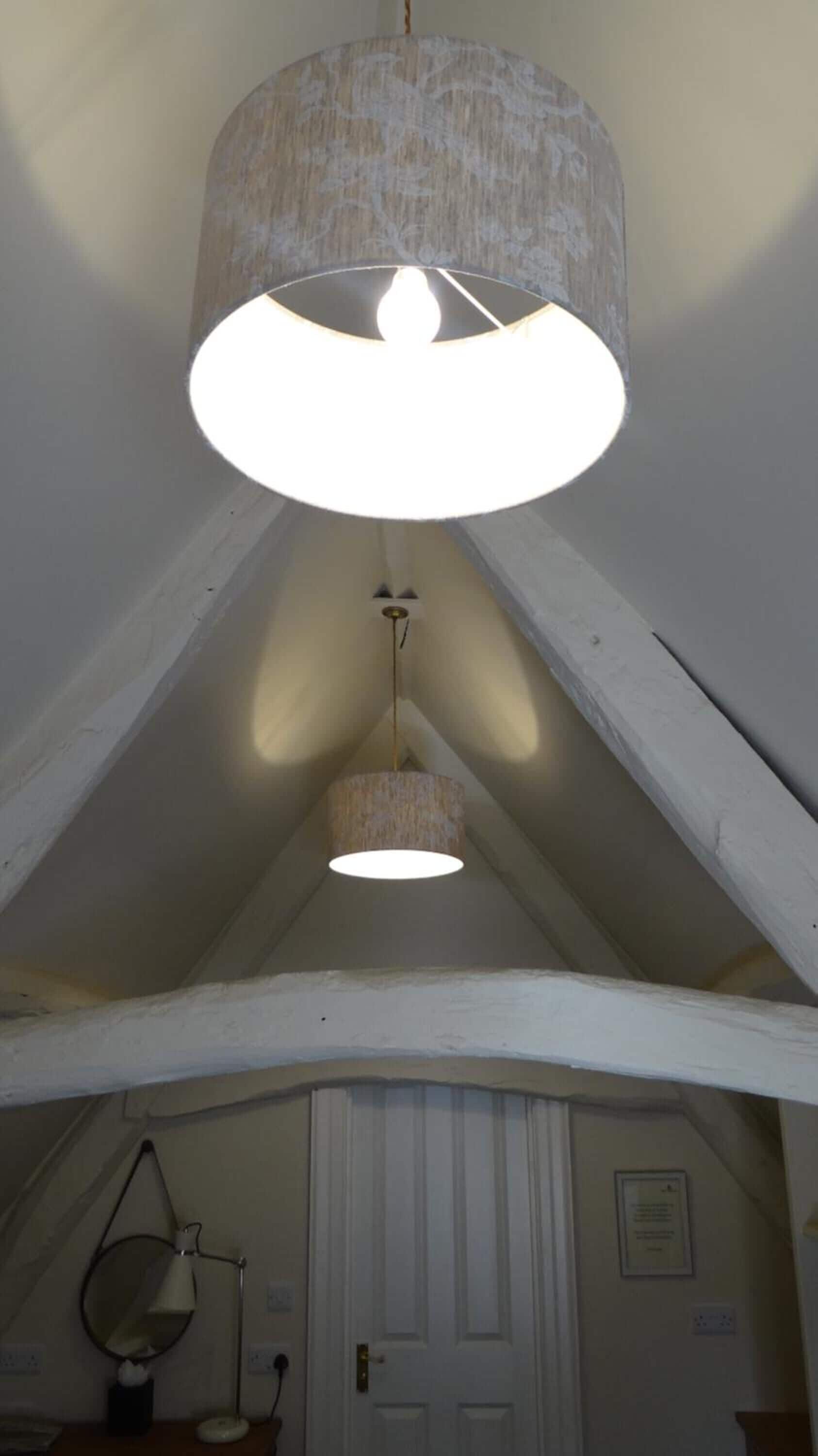 A room with a sloped ceiling, a white door, and a wall-mounted mirror.