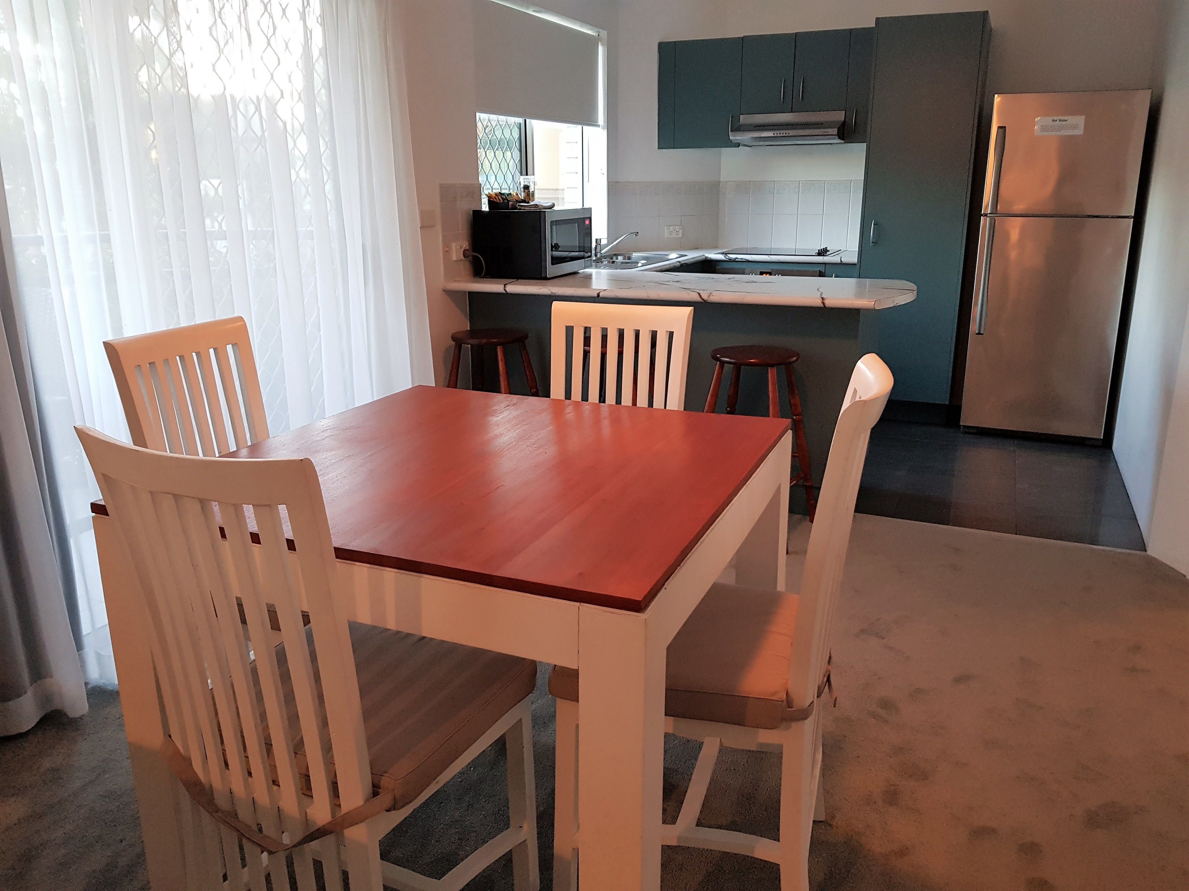 A compact kitchen with a dining area.